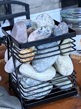 Black Metal Decorative Basket Filled with Smooth River Rocks